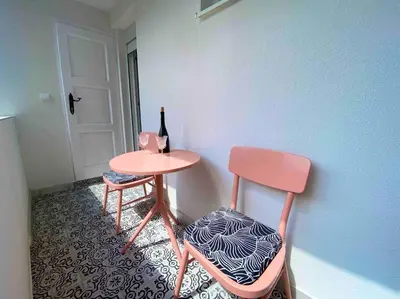 a table with a chair and a bottle of wine at Soba 23 in Belgrade