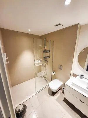 a bathroom with a shower and a toilet and a sink at Belgrade Waterfront - Beograd na vodi Lux Apartman in Belgrade