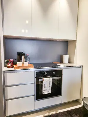 a kitchen with white cabinets and a stove at Belgrade Waterfront - Beograd na vodi Lux Apartman in Belgrade