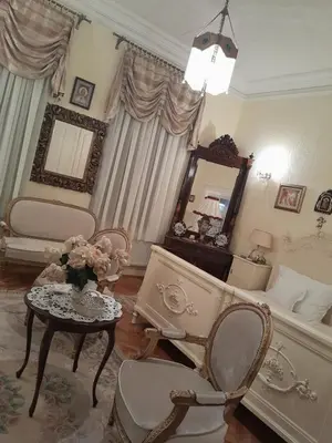 a living room with a bed and a table and chairs at VILA SREM in Ruma