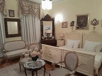 a bedroom with a bed and a table and chairs at VILA SREM in Ruma
