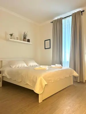 a bedroom with a bed and a large window at Pop luxury apartments in Belgrade