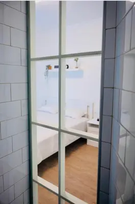 a glass door with a bed in a room at Pop luxury apartments in Belgrade