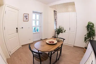 a dining room with a wooden table and chairs at Pop luxury apartments in Belgrade