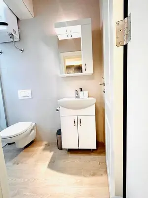 a bathroom with a white sink and a toilet at Pop luxury apartments in Belgrade