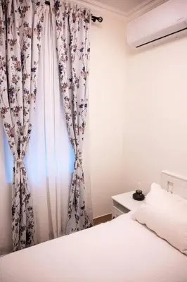 a bedroom with a bed and a curtain at Pop luxury apartments in Belgrade