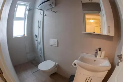 a bathroom with a toilet and a sink and a shower at Pop luxury apartments in Belgrade