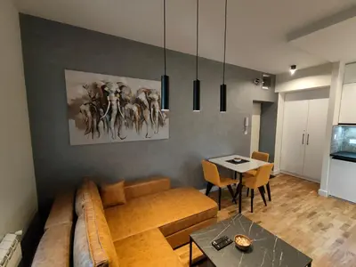a living room with a couch and a table at City Center Belgrade Dorćol Square in Belgrade