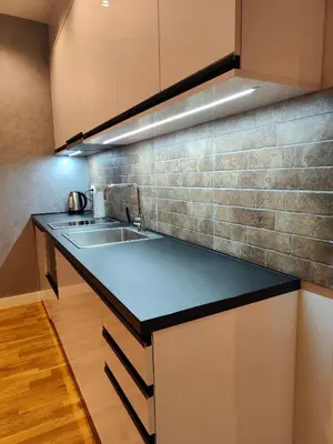 a kitchen with a sink and a counter top at City Center Belgrade Dorćol Square in Belgrade