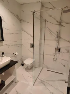 a bathroom with a shower and a toilet at City Center Belgrade Dorćol Square in Belgrade