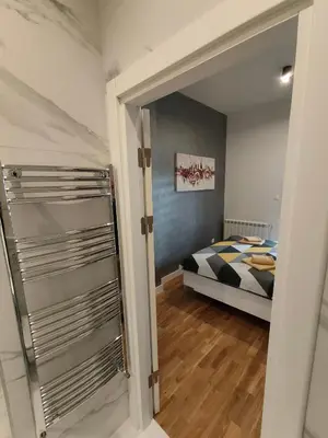 a bedroom with a bed and a glass door at City Center Belgrade Dorćol Square in Belgrade