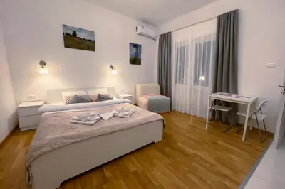 a bedroom with a bed and a desk in it at Serene Bulbuder Suite in Belgrade