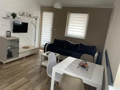 a living room with a couch and a table at Apartman Jany in Kijevo