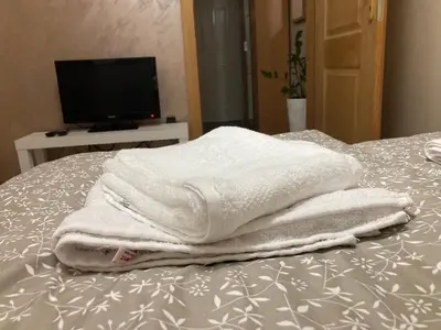 a pile of towels sitting on top of a bed at Apartman Jany in Kijevo