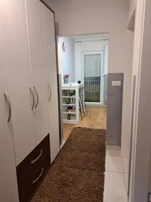 a room with a hallway with a door and a table at Apartman Sara 2 in Novi Grad