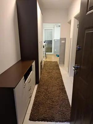 a kitchen with a hallway with a rug on the floor at Apartman Sara 2 in Novi Grad