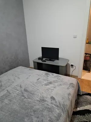 a bedroom with a bed and a desk with a computer at Apartman Sara 2 in Novi Grad
