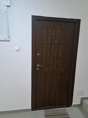 a wooden door in the corner of a room at Apartman Sara 2 in Novi Grad