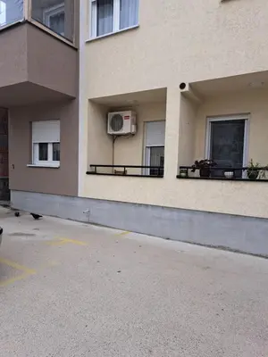a building with two balconies and a air conditioner at Apartman Sara 2 in Novi Grad