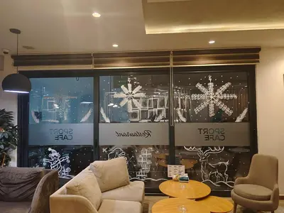 a living room with a couch and a christmas window at H.T Hotel in Belgrade
