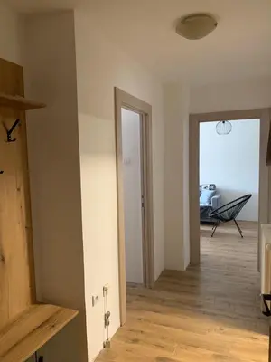 an empty room with a hallway with a table at Apartman ANN II in Pančevo