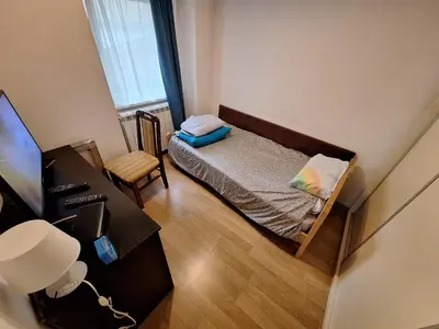 a small bedroom with a bed and a desk at River Walk 2 in Sajmište
