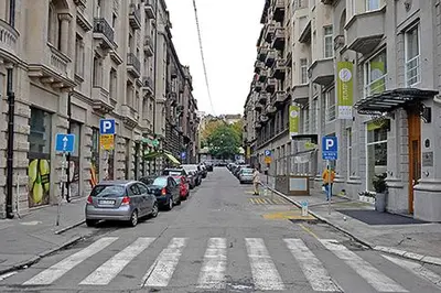 a city street with cars parked on the street at River Walk 2 in Sajmište
