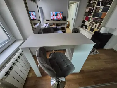 a white table and chairs in a living room at River Walk 2 in Sajmište