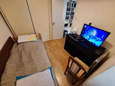a living room with a flat screen tv and a couch at River Walk 2 in Sajmište