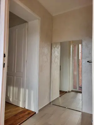 an empty room with a door and a mirror at SLEEP & GO in Surčin