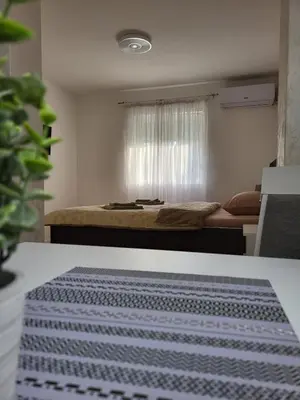 a bedroom with a bed with a blue and white rug at SLEEP & GO in Surčin