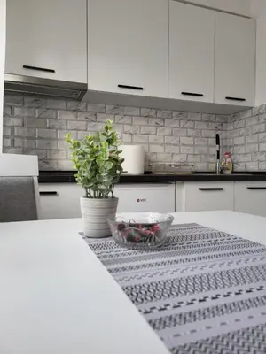 a kitchen with a table with a bowl of food on it at SLEEP & GO in Surčin