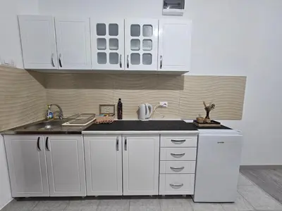 a kitchen with white cabinets and a sink at SLEEP & GO in Surčin