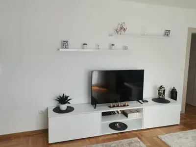 a white entertainment center with a flat screen tv at Noa in Ledine