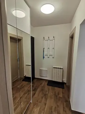 an empty room with a hallway with hangers and a glass door at Noa in Ledine