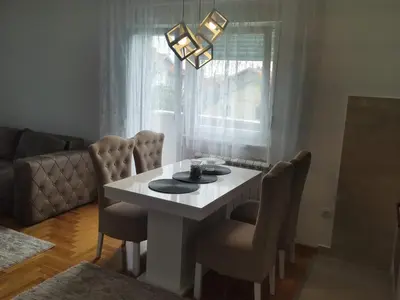 a dining room with a white table and chairs at Noa in Ledine