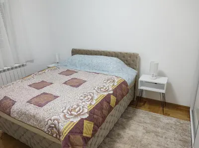 a bedroom with a bed and a table with a night stand at Noa in Ledine