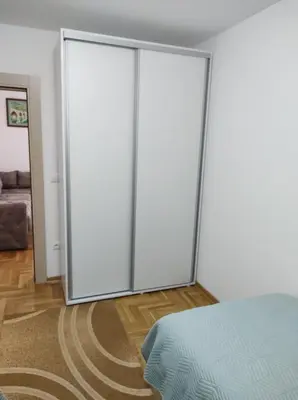 a sliding glass door in a room with a bed at Noa in Ledine