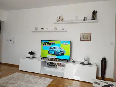 a television on a white entertainment center in a living room at Noa in Ledine