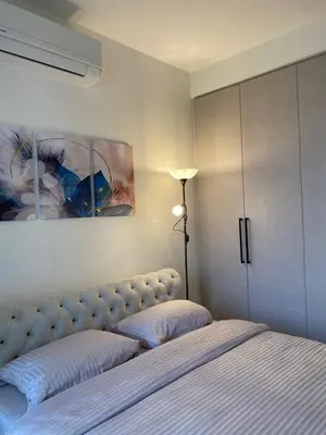 a bedroom with a bed and a painting on the wall at Symphony707 - Belgrade waterfront in Belgrade
