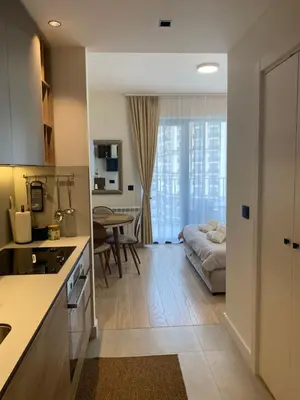 a kitchen and living room with a bed and a table at Symphony707 - Belgrade waterfront in Belgrade