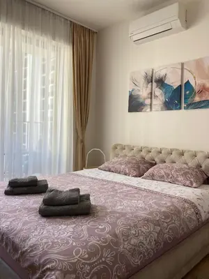 a bedroom with a large bed with two pillows on it at Symphony707 - Belgrade waterfront in Belgrade