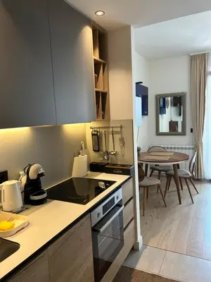 a kitchen with a counter top and a table at Symphony707 - Belgrade waterfront in Belgrade