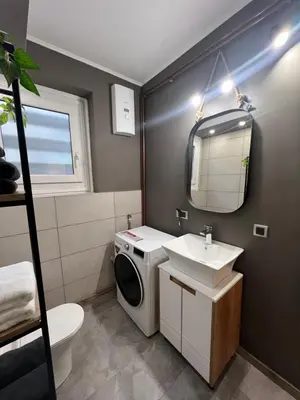 a bathroom with a washing machine and a sink at Admiral Downtown 2 in Belgrade