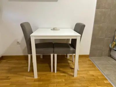 a table with two chairs and a white table at Apartman Pupin in Belgrade