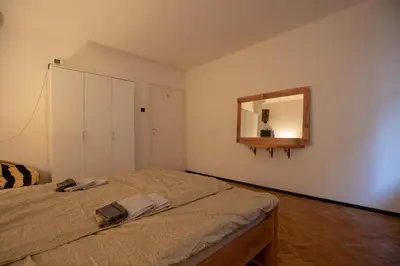 a bedroom with a bed with a mirror on the wall at St Marks in Belgrade