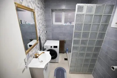 a bathroom with a sink and a washing machine at St Marks in Belgrade