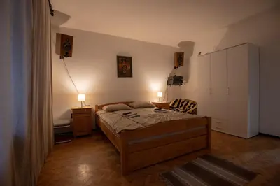 a bedroom with a bed and a chair in it at St Marks in Belgrade