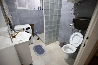 a small bathroom with a toilet and a sink at St Marks in Belgrade