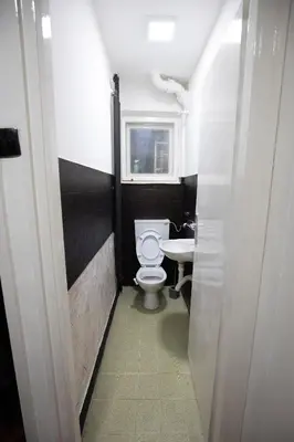 a small bathroom with a toilet and a sink at St Marks in Belgrade